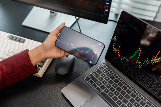Professional investor monitoring financial markets and analyzing investment opportunities in a modern office, representing stock trading, market research, portfolio management.