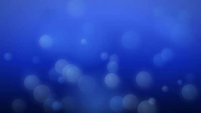 Abstract blue background with floating soft bokeh lights and shimmering particles in slow motion