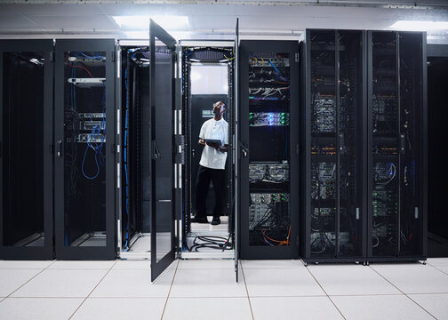 IT Professional Monitoring Network Equipment in Server Room