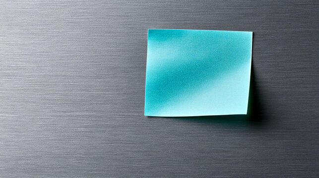 Blue Square Sticky Note Paper Attached To Brushed Metal Surface
