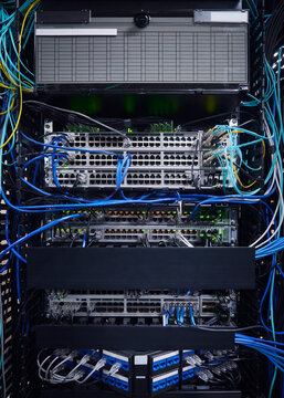 Network switches and Ethernet cables connected inside a modern data center server rack