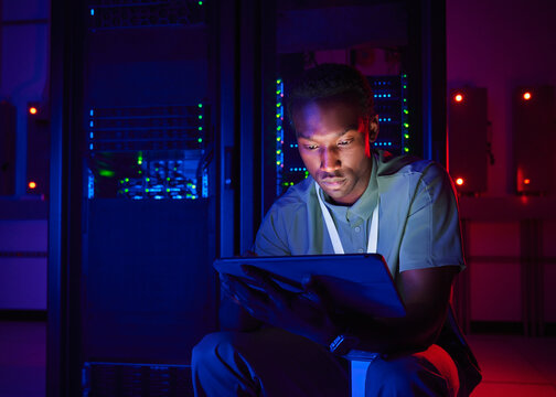IT Professional Monitoring Data Center Servers with Digital Tablet