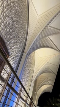 Panning shot of illuminated modern Islamic architecture with geometric patterns at Saudi airport.