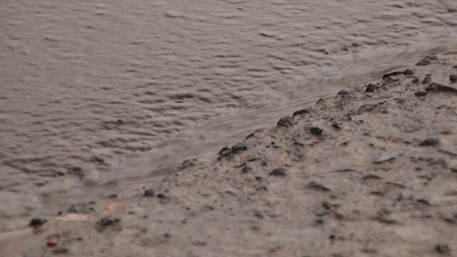 Brown Muddy Water Flowing on Dirt Ground