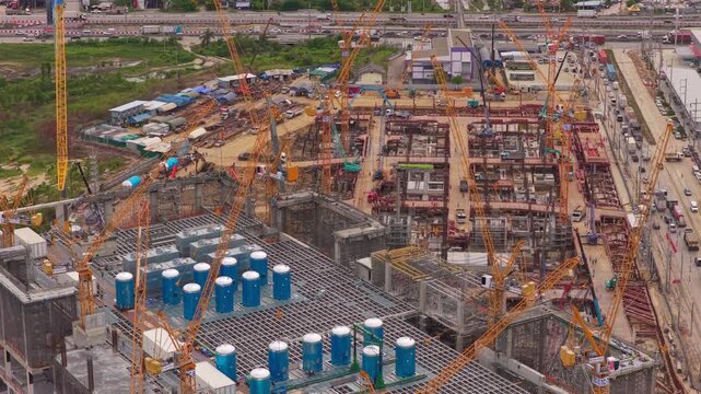 Aerial perspective of a massive hyperscale data center under construction, highlighting the complex engineering and crane operations