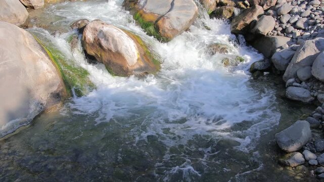 River water flowing over rocks in mountain stream
