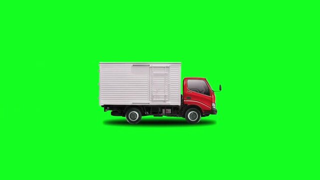 Red commercial delivery cargo truck driving sideways against a keyable bright green screen background