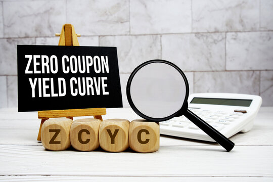 ZCYC Zero Coupon Yield Curve text with calculator magnifying glass and on wooden background