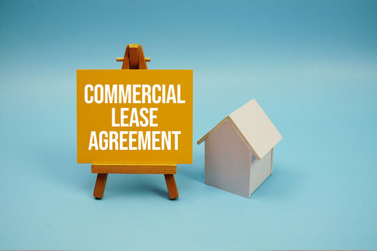 Commercial Lease Agreement text with house model on blue background