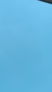 Minimalist solid light blue texture background with a clear gradient representing a cloudless sunny sky for creative copy space