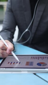 slow motion scene businessman hand pointing in dashboard statistic chart on digital tablet screen in office room to planning or analyzing the company's profit or business strategy concept