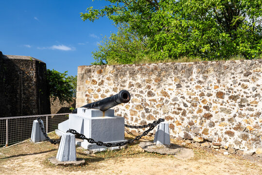 Old military cannon mounted on a stone rampart at Fort Napoleon des Saintes in Guadeloupe, Caribbean France