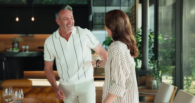 Face, hug and mature couple in home for bonding, connection and help with dinner table. Portrait, marriage and man with woman embrace for love, relationship and affection with wine glasses for supper