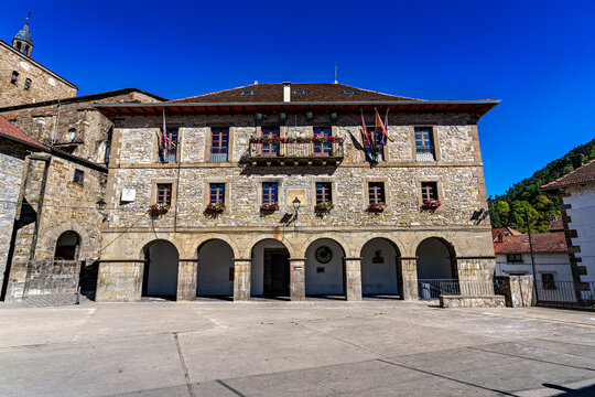 Strolling through Isaba in Roncal valley, Pyrenees, Navarre in Spain with brownish tiled roofs of residential buildings
