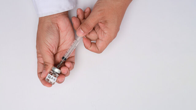 Doctor hand preparing glp1 medicine injection with syringe from vial showing focused care on white background