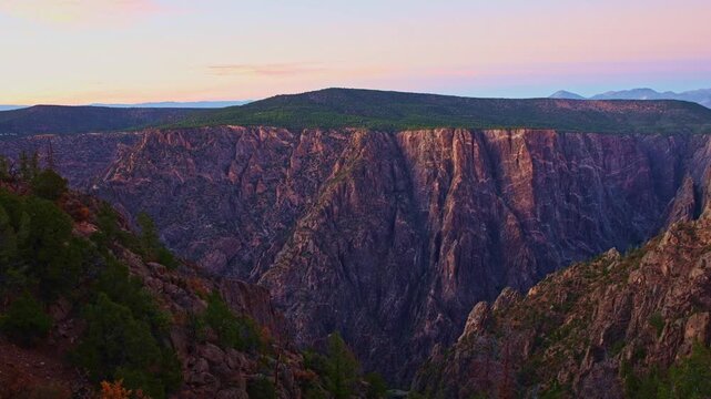 Subtle twilight colors illuminate the iconic marbled pegmatite veins of Painted Wall viewed from Warner Point in Black Canyon