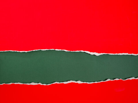 Torn Red Paper Over Green Background for Christmas with Copy Space
