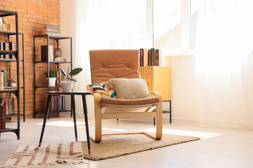 Interior design and home comfort, cozy reading nook with leather armchair and bookshelf in a bright living room with natural sunlight © Pixel-Shot