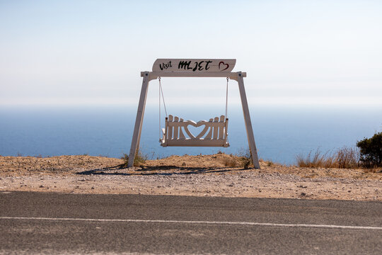A striking tourist spot on Mljet Island featuring an empty swing surrounded by lush Mediterranean vegetation and tranquil natural scenery. 