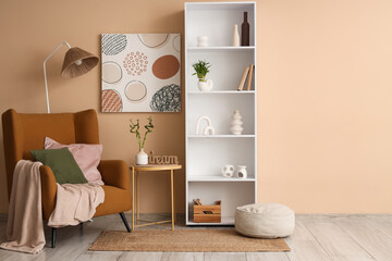Interior design and home comfort, cozy living room with armchair and bookshelf for modern lifestyle and wellness in a minimalist apartment © Pixel-Shot
