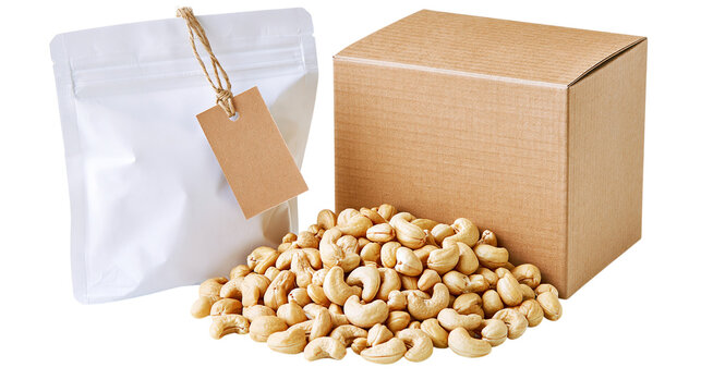 Pile of roasted cashew nuts with a white pouch and brown cardboard box isolated on transparent background PNG element