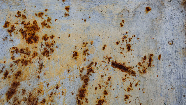 Weathered metal surface with orange rust texture and grey paint