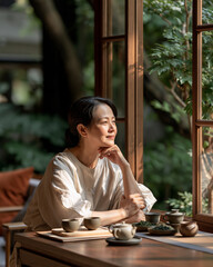 Obraz premium Woman enjoying quiet tea moment in Taipei