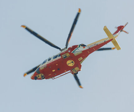 August 6, 2026. Fiumaretta di Ameglia, Liguria, Italy: A Coast Guard helicopter in flight against a blue sky; maritime patrol and search-and-rescue operations.