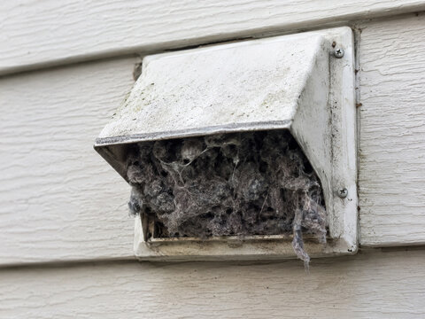 Exterior dryer vent hood clogged with heavy lint buildup