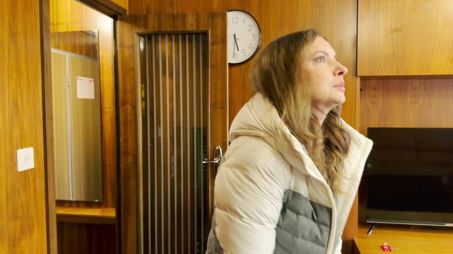 A mother and her young son stand curiously inside a wooden cabin on a cruise ship along the Neva River. They feel excited and cozy as they arrive. Their quiet moment fills with warmth.
