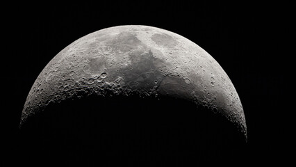 Detailed crescent moon showing craters and surface details against a dark sky. © wannasak