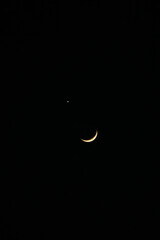 Slender crescent moon accompanied by the bright point of light that is Venus signals a very close celestial alignment or conjunction. The Moon passes directly in front of the planet for a brief moment © Joshua Prasetyadi