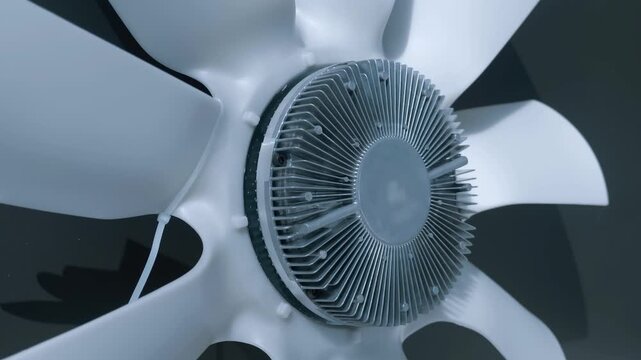 A huge white fan with cooling fins for a powerful truck engine is presented at the exhibition. Closeup. Shot in motion