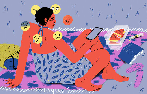 Emojis surround woman with smart phone relaxing on blanket in summer grass