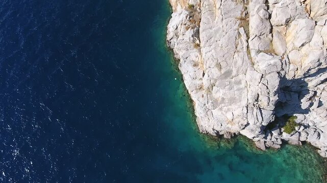 Aerial drone view of rugged sea cliffs and steep rocky coast with untouched natural terrain.