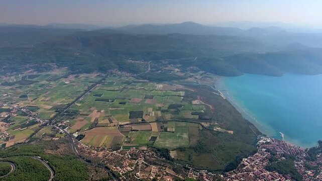Aerial drone panorama of Akyaka Gokova in Mugla Turkey with delta plain, farms, forest, and sea.