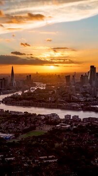 Beautiful sunset timelapse view of the urban skyline of London, England, with golden sunshine and cloudscape