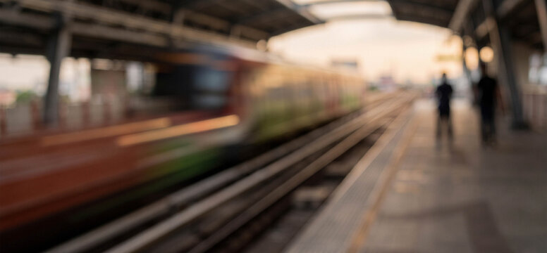 a blurred image of a train arriving at a station during sunset, with silhouettes of passengers waiting on the platform, capturing a sense of motion and anticipation