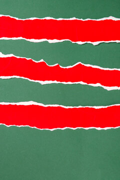 Three Torn Red Paper Strips on a Green Christmas Background