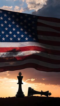 American Flag with Fallen Chess King at Sunset &ndash; Political Conflict and Power Concept