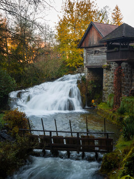 Traditional wooden watermill house above rushing waterfall in autumn, Rastoke, Slunj, Croatia