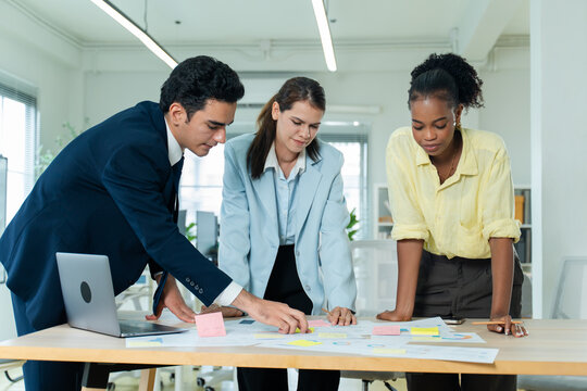 business people meeting and discussion in the office while working on a company project.Business teamwork and team doing corporate research in discussion together with technology in workplace