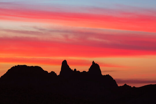 Silhouette of Mule Ears rock formations at Sunrise in a park
