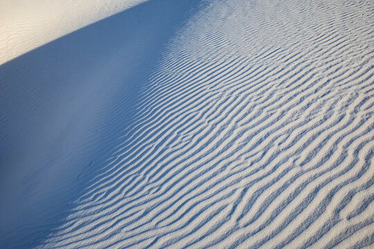 Wind ripples on white sand dunes in a park