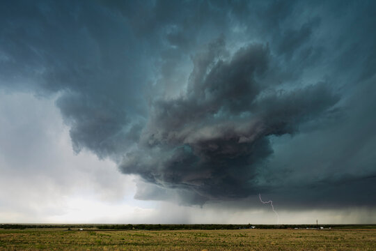 Supercell storm with lightning over rural field in byers, colorado