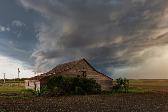 Old Barn under Storm Clouds in wood, south dakota, USA
