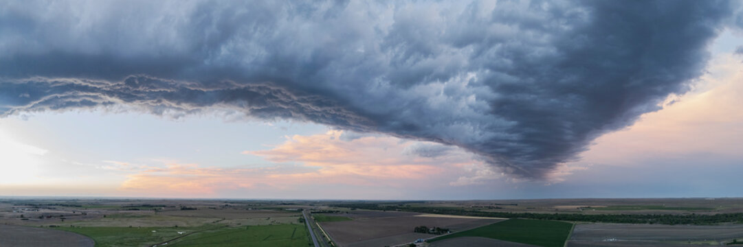 Storm cloud over farmland near sterling colorado at sunset