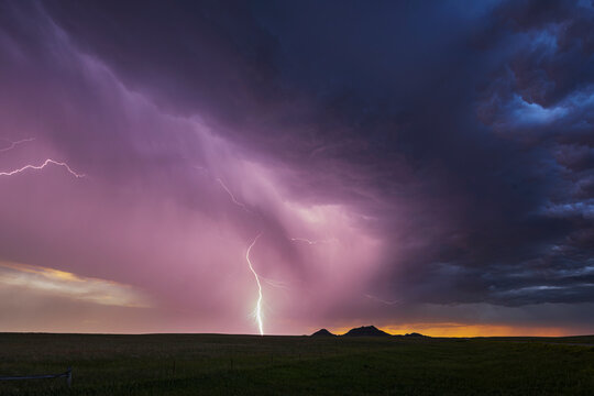 Lightning strike over open plains at sunset in redig, south dakota