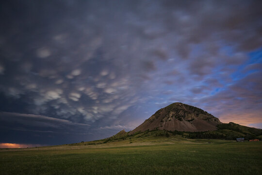 Receding Storm over bear Butte mountain in south dakota grassland