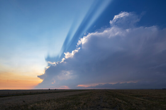 Storm cloud with crepuscular rays at Sunset in grover, colorado